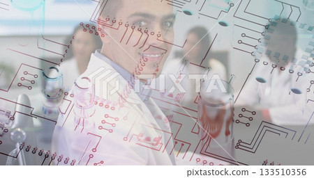 Lab coat–clad researchers analyzing clear board with circuit diagrams in lab, with glassware Lab coat–clad researchers analyzing clear board with circuit diagrams in lab, with glassware 133510356