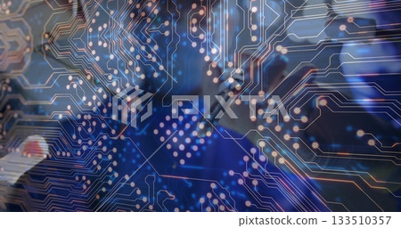 Heating soldering iron, technician attaching solder wire on PCB at bench, with digital overlay 133510357