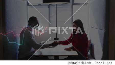Shaking hands professional man and woman meeting in office booth, with clipboard and floor lamp 133510433