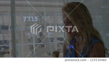 Leaning businesswoman analyzing digital data grid overlay in modern office with plant, copy space Leaning businesswoman analyzing digital data grid overlay in modern office with plant, copy space 133510460