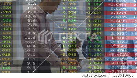 Reviewing team analyzing financial charts on transparent board at conference table, with laptops Reviewing team analyzing financial charts on transparent board at conference table, with laptops 133510466