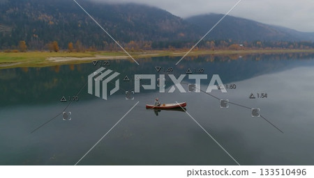 Lone paddler wearing knit cap and life vest paddling across lake, with digital measurement overlays Lone paddler wearing knit cap and life vest paddling across lake, with digital measurement overlays 133510496