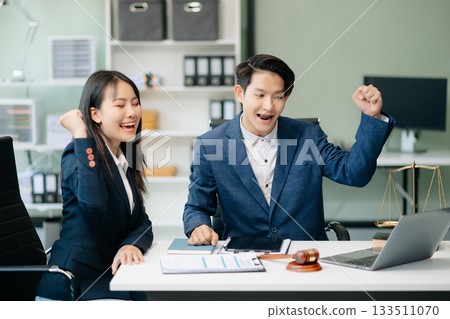 Asian business team and lawyers discussing contract papers sitting at the table. Concepts of law, advice, legal services. 133511070