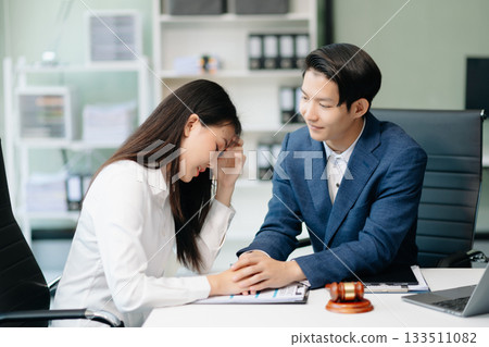 Asian business team and lawyers discussing contract papers sitting at the table. Concepts of law, advice, legal services. Asian business team and lawyers discussing contract papers sitting at the table. Concepts of law, advice, legal services. 133511082