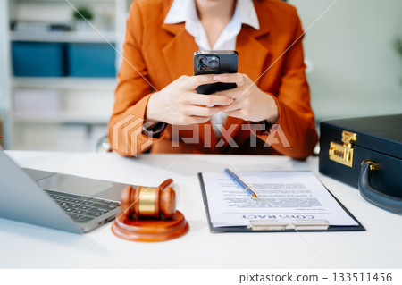 justice and law concept.Female judge in a courtroom on table and Counselor or Male lawyer working 133511456