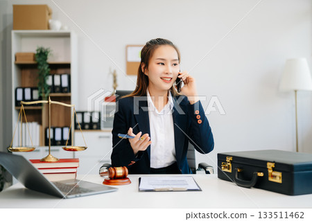 Asian lawyer woman working with a laptop and tablet in a law office. Legal and legal service concept. 133511462