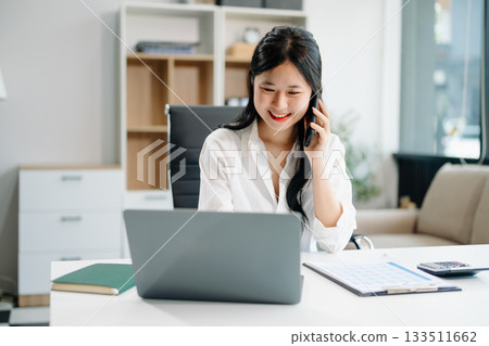 businesswoman working at office with laptop, tablet and taking notes on the paper. 133511662