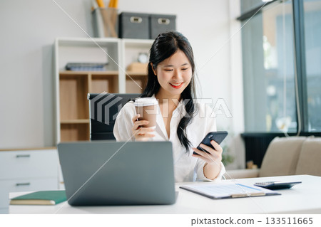 businesswoman working at office with laptop, tablet and taking notes on the paper. businesswoman working at office with laptop, tablet and taking notes on the paper. 133511665