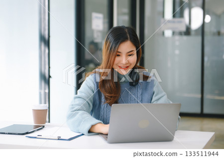 Woman freelancer is working her job on computer tablet and laptop Doing accounting analysis report real estate investment data, Financial Woman freelancer is working her job on computer tablet and laptop Doing accounting analysis report real estate investment data, Financial 133511944