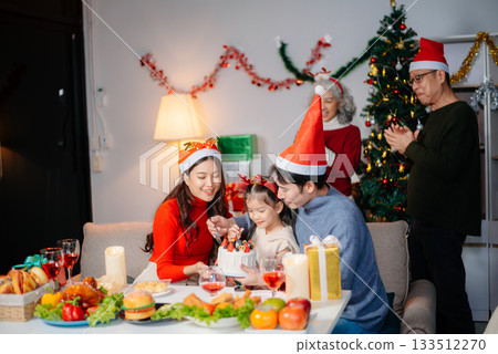 Joyful Asian family gathered for a Christmas feast, exchanging gifts, and celebrating the holiday season with love Joyful Asian family gathered for a Christmas feast, exchanging gifts, and celebrating the holiday season with love 133512270
