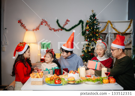 Joyful Asian family celebrating Christmas together with gifts, festive food, and decorations, capturing love, Joyful Asian family celebrating Christmas together with gifts, festive food, and decorations, capturing love, 133512331
