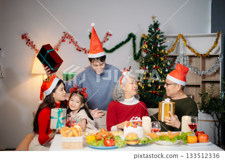Joyful Asian family celebrating Christmas together with gifts, festive food, and decorations, capturing love, Joyful Asian family celebrating Christmas together with gifts, festive food, and decorations, capturing love, 133512336