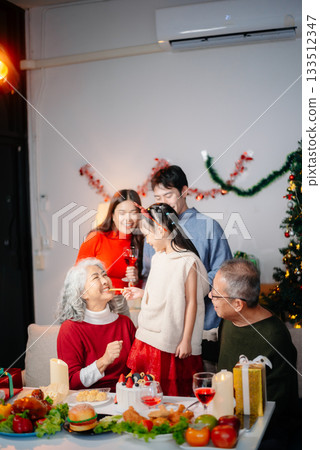 Celebrate Christmas with family in a cozy, festive setting filled with gifts, love, and joy. Celebrate Christmas with family in a cozy, festive setting filled with gifts, love, and joy. 133512347
