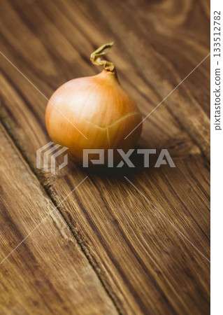 Fresh onion on wooden table 133512782