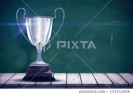 Close up of trophy on table by green wall 133512856