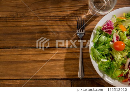 Healthy bowl of salad on wooden table Healthy bowl of salad on wooden table 133512910