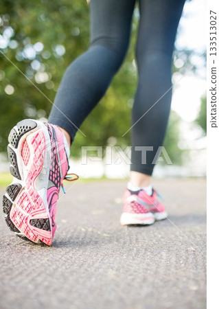 Low section of woman running on footpath Low section of woman running on footpath 133513027