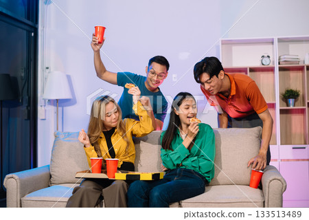 Young Asian Friends Celebrating with Laughter and Food at a Modern Evening Party 133513489