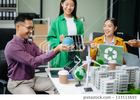 Asian professionals collaborate on sustainable energy solutions with wind turbines, solar panels, and eco friendly models 133513693