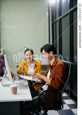 Business teamwork and collaboration among Asian professionals in a modern office Business teamwork and collaboration among Asian professionals in a modern office 133513719