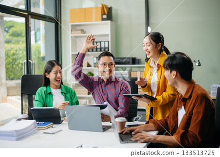 Business teamwork and collaboration among Asian professionals in a modern office Business teamwork and collaboration among Asian professionals in a modern office 133513725
