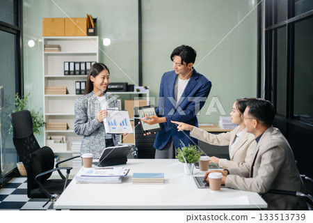 Business teamwork and collaboration among Asian professionals in a modern office Business teamwork and collaboration among Asian professionals in a modern office 133513739