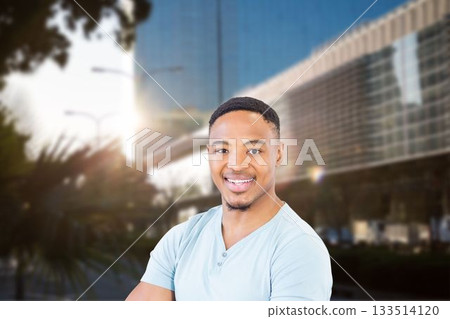 Portrait of smiling man against modern building in city 133514120