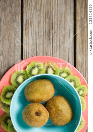Kiwi fruits arranged on wooden table 133514136