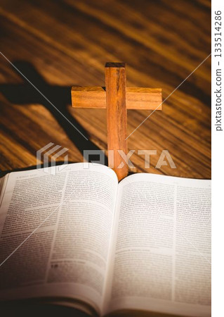 Close-up of wooden cross by bible 133514286