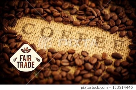 Flat illustration is showing roasted coffee beans on coarse burlap bag with Fair Trade label Flat illustration is showing roasted coffee beans on coarse burlap bag with Fair Trade label 133514440