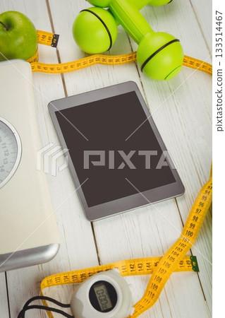 High angle view of digital tablet and tape measure 133514467