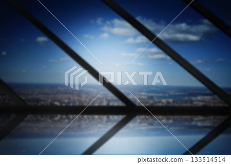City against blue sky seen through metal grate City against blue sky seen through metal grate 133514514