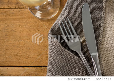 Fork and knife on sack at wooden table Fork and knife on sack at wooden table 133514547
