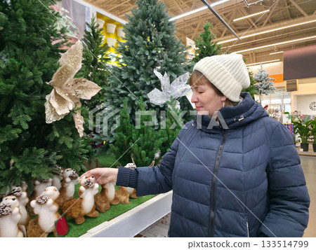 Woman Enjoys Holiday Shopping, Selecting Christmas Decor 133514799