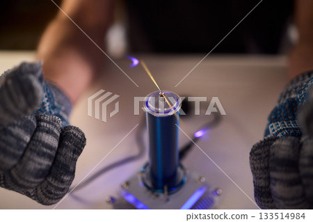 Expert carefully calibrates plasma equipment using sensitive techniques, Research professional employs meticulous methods to adjust plasma probe with expert precision Expert carefully calibrates plasma equipment using sensitive techniques, Research professional employs meticulous methods to adjust plasma probe with expert precision 133514984