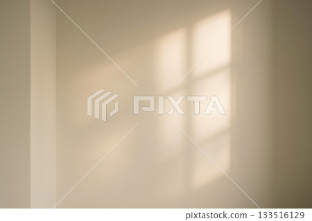 Soft morning light and warm shadows illuminating the white walls 133516129