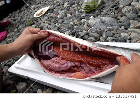 Fresh salmon innards and salmon roe are prepared and cooked 133517451