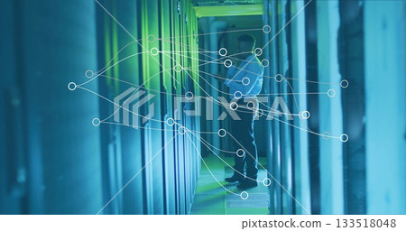 IT technician in white shirt inspecting server cabinets in server room, with LED network overlay IT technician in white shirt inspecting server cabinets in server room, with LED network overlay 133518048