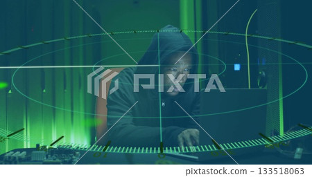 Monitoring hacker in hoodie scanning laptop and circuit board in data center, holographic overlay Monitoring hacker in hoodie scanning laptop and circuit board in data center, holographic overlay 133518063