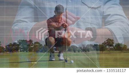 Kneeling golfer in polo cap aligning putter behind golf ball on green, showing smartwatch charts Kneeling golfer in polo cap aligning putter behind golf ball on green, showing smartwatch charts 133518117