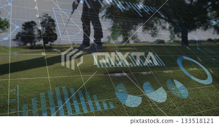 Golfer in polo shirt viewing digital overlays on putting green, with golf ball and putter 133518121