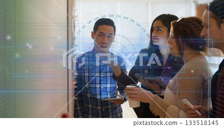 Collaborating team analyzing board diagrams, notes in office with tablets phones and coffee cups Collaborating team analyzing board diagrams, notes in office with tablets phones and coffee cups 133518145