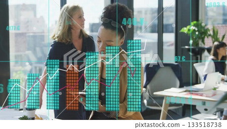 Reviewing smartphone, Black woman wearing blazer standing at desk in modern office, with laptop Reviewing smartphone, Black woman wearing blazer standing at desk in modern office, with laptop 133518738