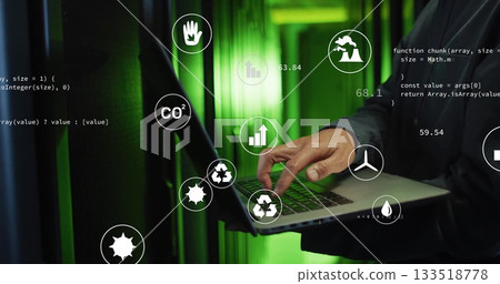 Korean man in jacket monitoring server racks in data center, with laptop, eco icons and JavaScript 133518778