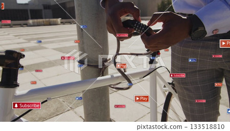 Man in shirt locking white bicycle in plaza, watch visible, Subscribe Play Like icons, copy space Man in shirt locking white bicycle in plaza, watch visible, Subscribe Play Like icons, copy space 133518810
