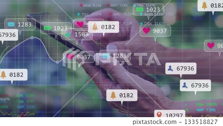 Mature adult hands holding smartphone on digital analytics interface, with overlay notifications 133518827