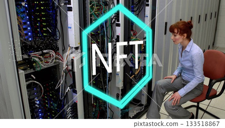 Sitting IT tech managing cables near server racks in server room, with NFT overlay, copy space 133518867