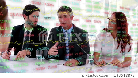 Reviewing data on glass screen, team in suits discussing charts in boardroom, with notebooks, water 133518875