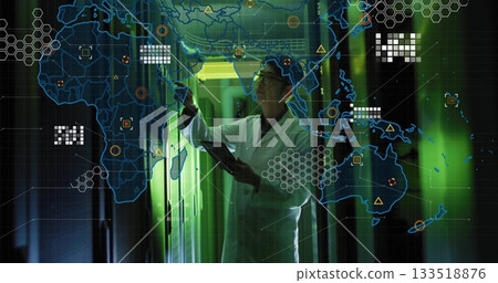Reaching Korean engineer wearing lab coat holding tablet in green data center corridor, network map 133518876