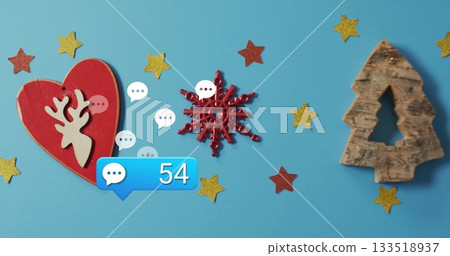 Showing red snowflake shining on blue table with heart ornament, tree cutout, chat notification 54 133518937